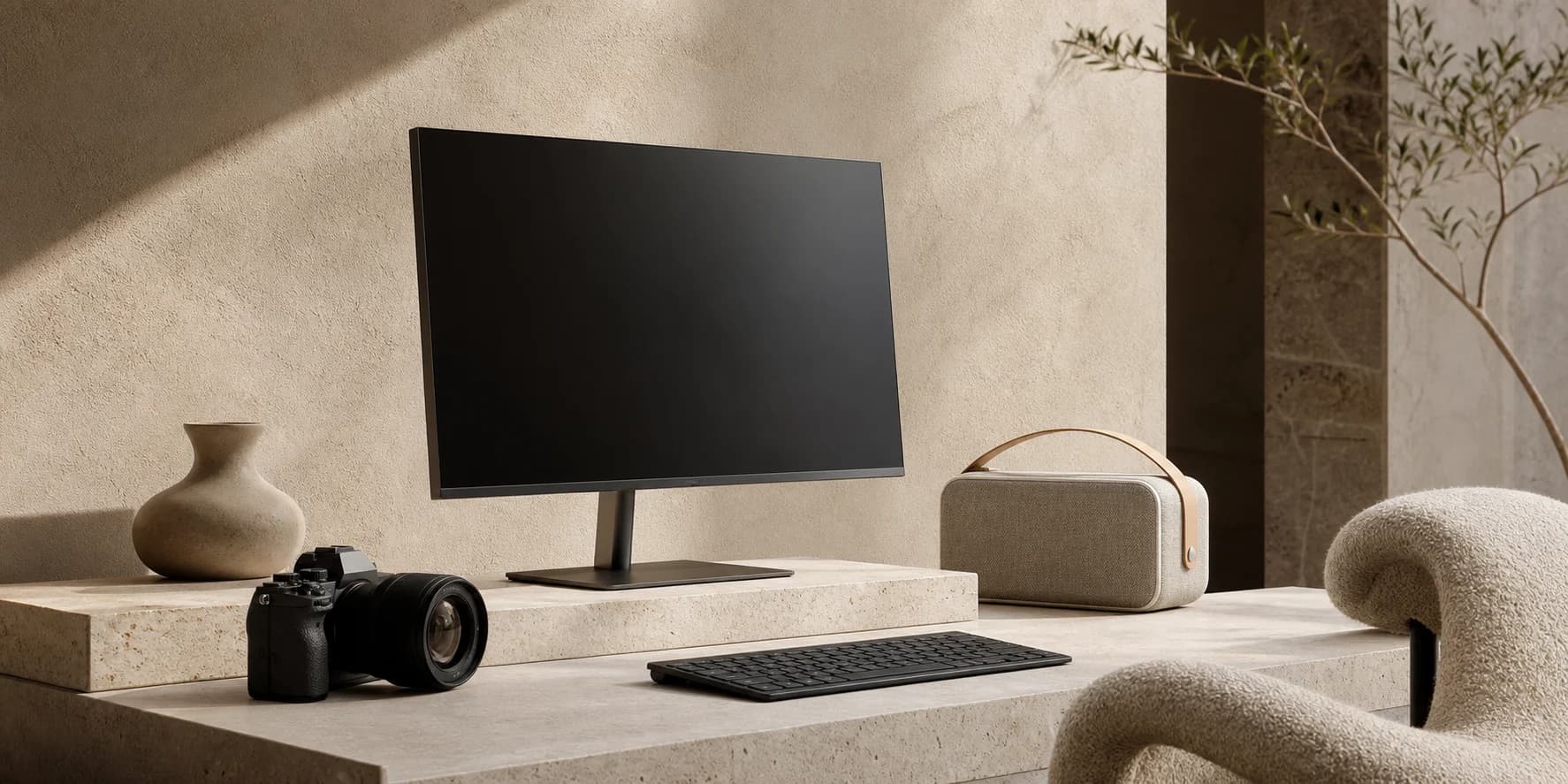Premium work and living collection with monitor, keyboard, camera, speaker, chair, and ceramic decor