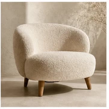 Cream boucle lounge chair in a warm neutral setting
